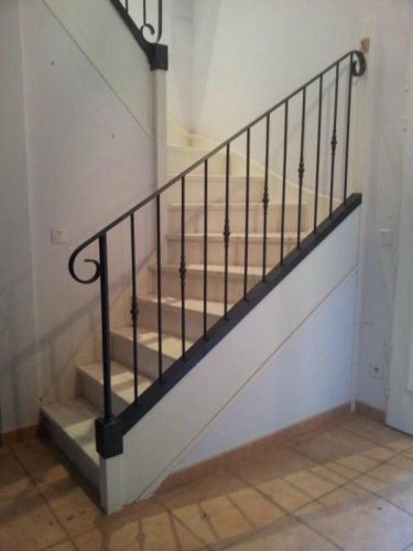 rampe en fer forgé sur escalier bois à Paris